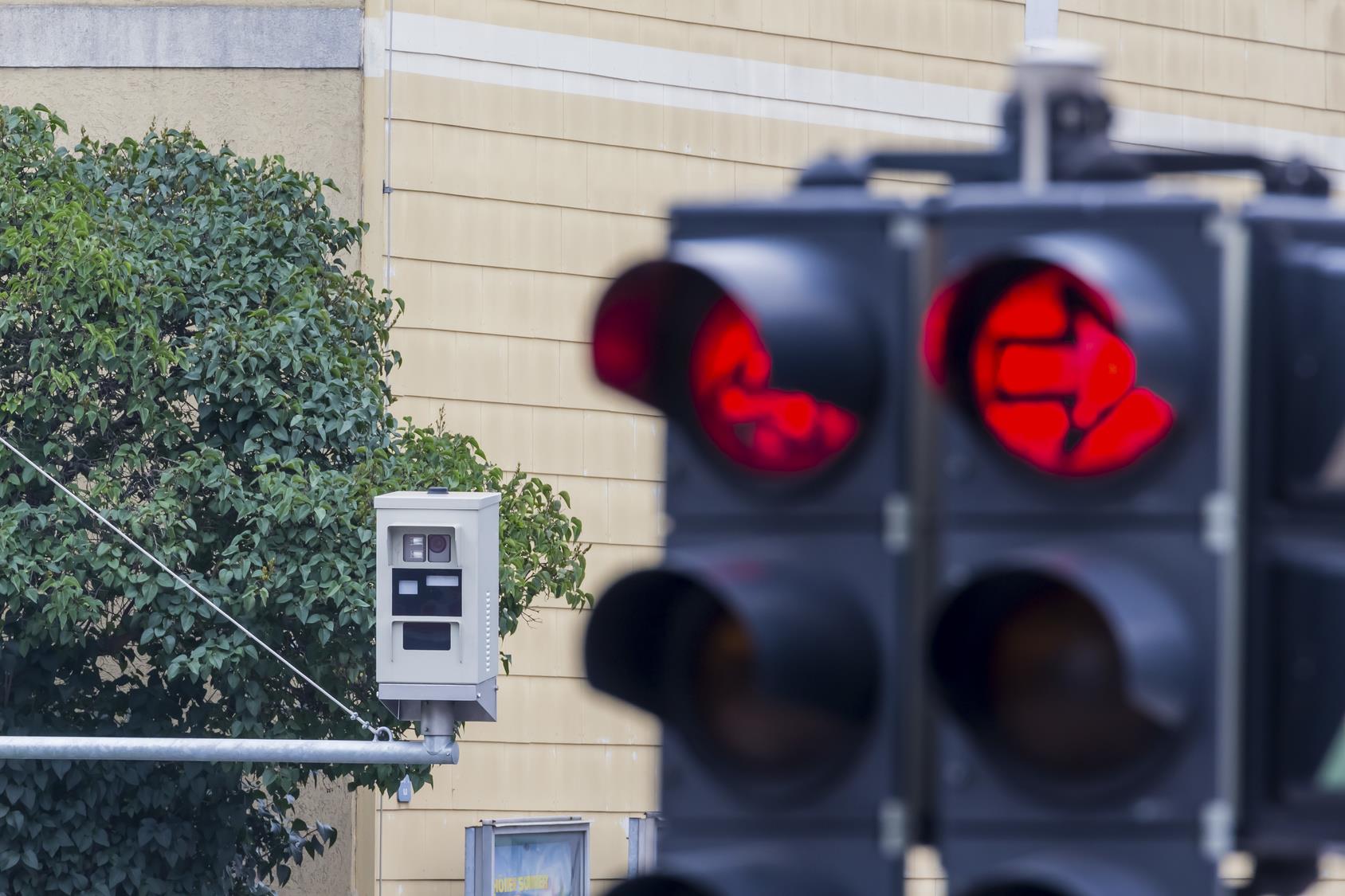 the red light of a traffic light is monitored by a red-light camera.